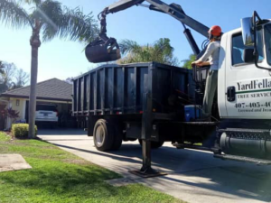 A YardFellas Tree Services professional operating a grapple truck for debris removal in Casselberry, FL.