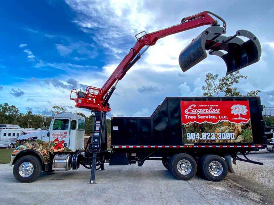 A specialized grapple truck used by Eagerton Tree Service, LLC for tree removal and debris hauling in Ponte Vedra Beach, FL.