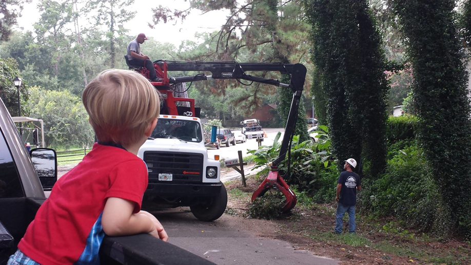 A grapple truck and crew from All American Tree Pro removing tree debris in Tallahassee, FL.