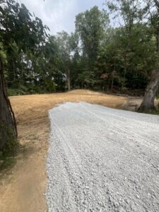 A newly installed gravel path or driveway in a wooded residential area by Lankford Dirt Works LLC in Indianapolis, IN.
