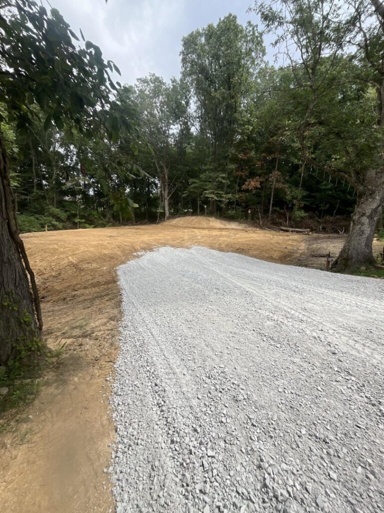 A newly installed gravel path or driveway in a wooded residential area by Lankford Dirt Works LLC in Indianapolis, IN.