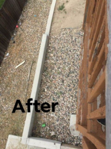 Newly installed gravel pathway and concrete border next to a wooden deck by Js Handyman Services LLC in Manassas, VA.
