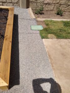 Gravel pathway installed next to a wooden planter box by Shane's Handyman Service in Edmond, OK.