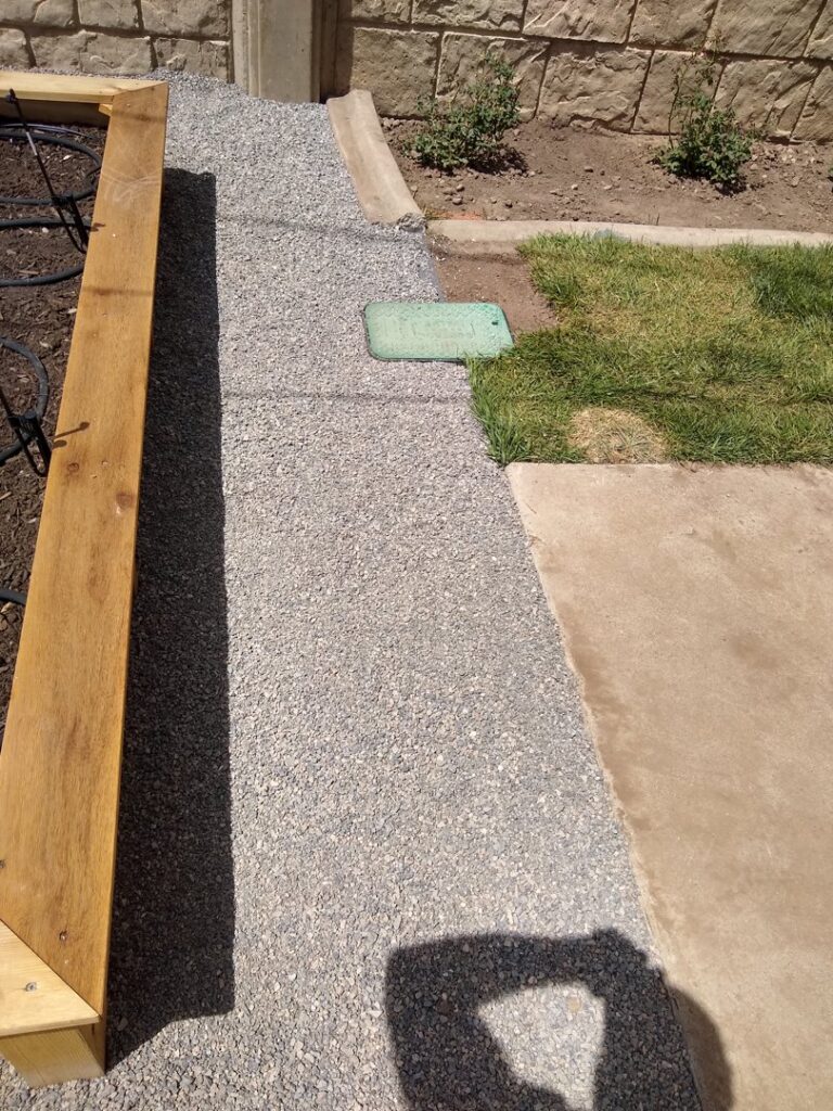 Gravel pathway installed next to a wooden planter box by Shane's Handyman Service in Edmond, OK.