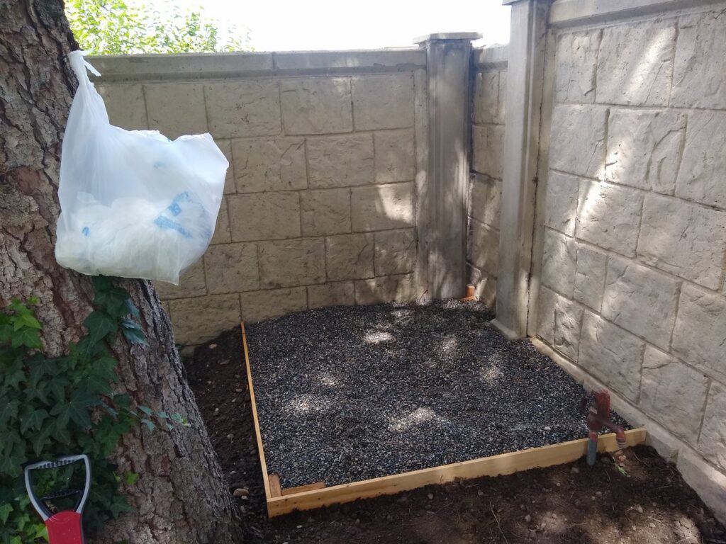 Small gravel patio area with wooden border installed by Shane's Handyman Service in Edmond, OK.