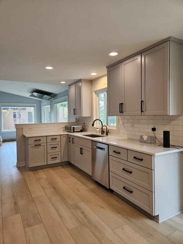 A bright kitchen remodel featuring light gray cabinets, white subway tile backsplash, and new flooring by Boisen Remodeling LLC in Appleton, WI.