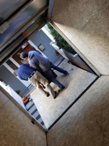 Green Clover team members loading a large piece of furniture into a junk removal trailer in Quincy, MA.