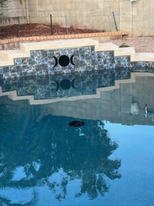 A pool with green, dirty water, indicating a need for cleaning and maintenance from Aqua Squad Pools & Landscaping in Gilbert, AZ.