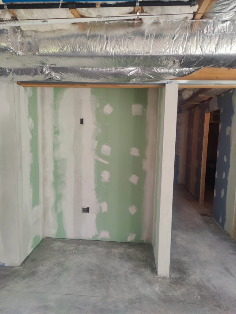 Green drywall installed and mudded in a room, showcasing work by Drywall Paint Plus in Worcester, MA.