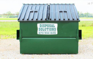 A green dumpster from Disposal Solutions LLC, ready for junk removal services in Jonesboro, AR.