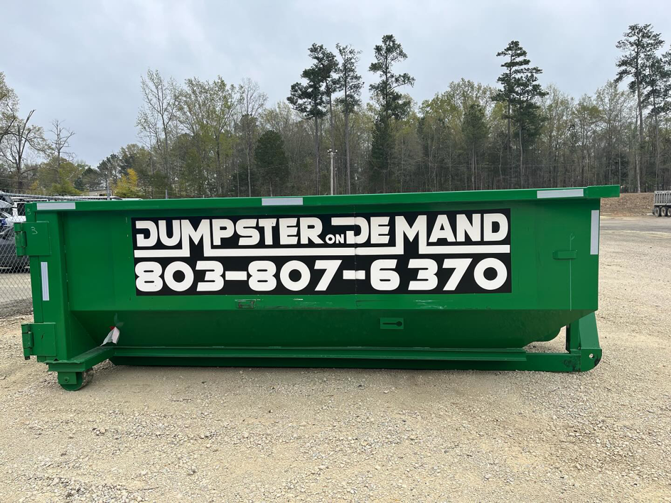 A large green dumpster from Dumpster on Demand, ready for junk removal services in Columbia, SC.