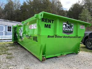 A bright green dumpster rental from Dan's Disposal LLC, ready for junk removal in Richmond, KY.