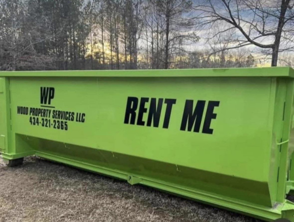 A bright green dumpster from Wood Property Services & Dumpster Rental LLC placed in a rural setting in Wilmington, NC.