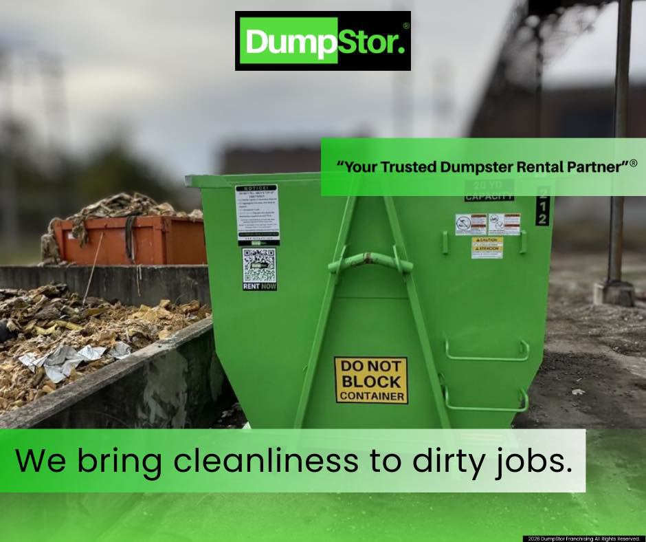 A green DumpStor dumpster positioned at a job site with debris in the background, ready for junk removal in Charlotte, NC.