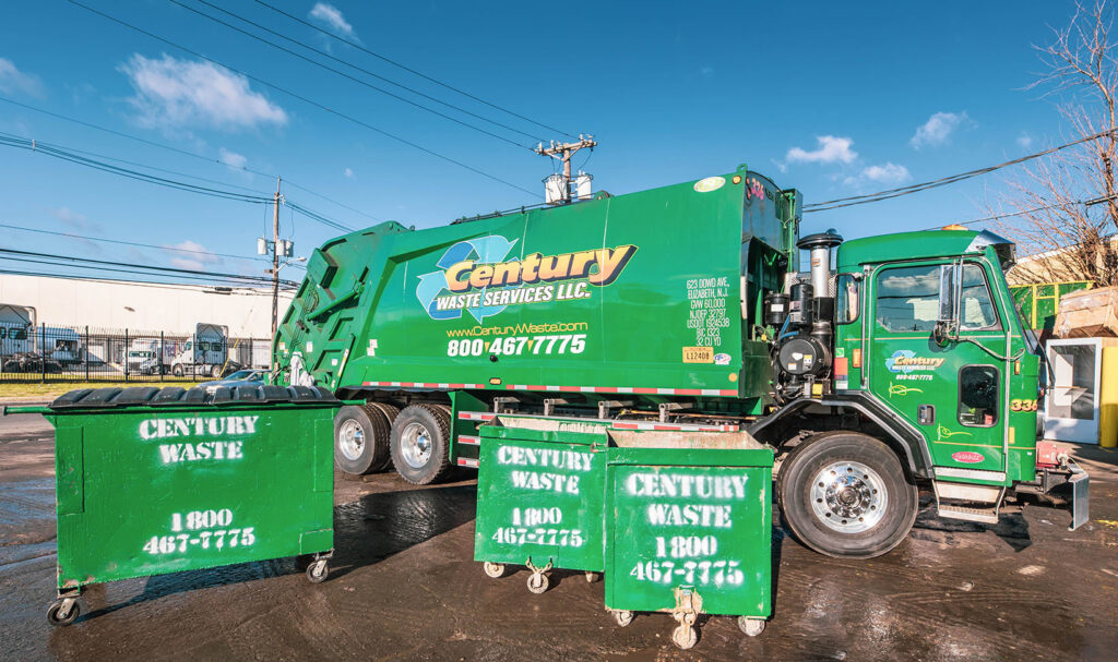A green Century Waste Management garbage truck with several small dumpsters for waste and junk removal in Sterling Heights, MI.