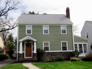 A two-story green house with new siding and roofing completed by Bartlett Brainard Products Co. in West Hartford, CT.