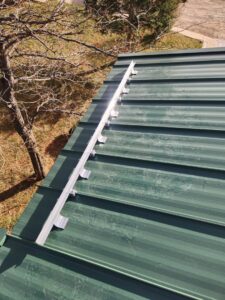 Green metal roof with snow guards installed by RC Contracting in Chesterfield, MO.