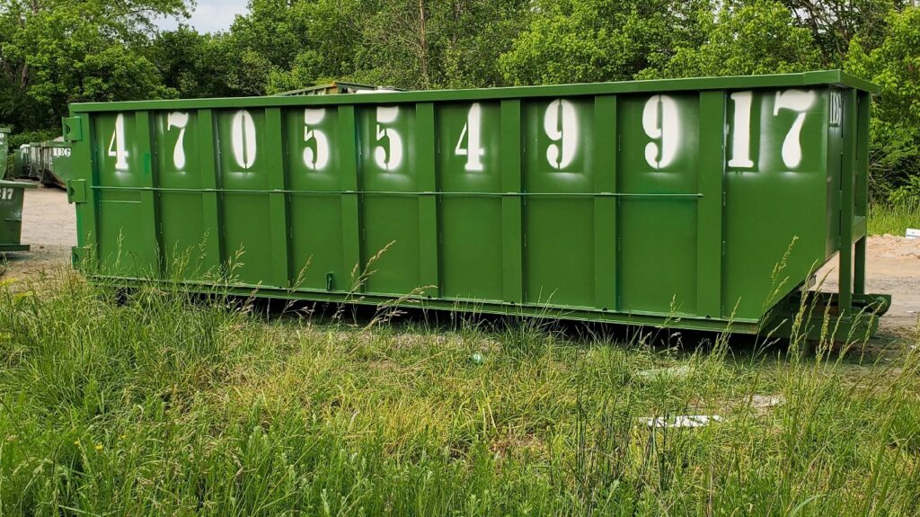 A large green roll-off dumpster from IEG Disposal ready for general junk removal in Canton, GA.
