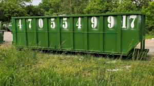 A large green roll-off dumpster from IEG Disposal ready for general junk removal in Canton, GA.