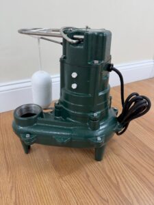 A green sump pump with a float switch, a key piece of equipment used by B-Dry System of New England in North Billerica, MA.