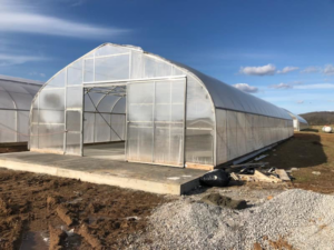 A large greenhouse structure with a solid concrete base built by Fairview Concrete in Hopkinsville, KY.