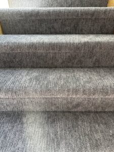 Close-up of newly installed grey carpet on a staircase by Creative Carpets in North Las Vegas, NV.