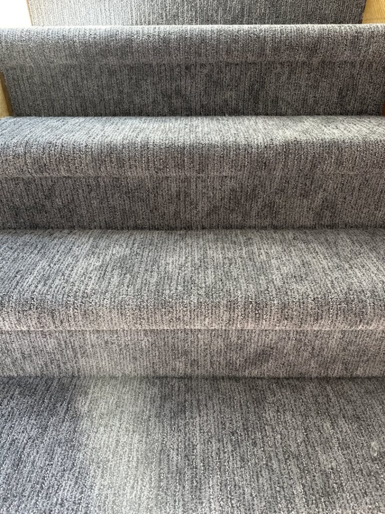 Close-up of newly installed grey carpet on a staircase by Creative Carpets in North Las Vegas, NV.