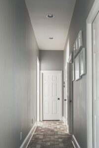 A modern hallway with freshly painted grey walls and a tiled floor by Harpeth Painting, LLC. in Nashville, TN.