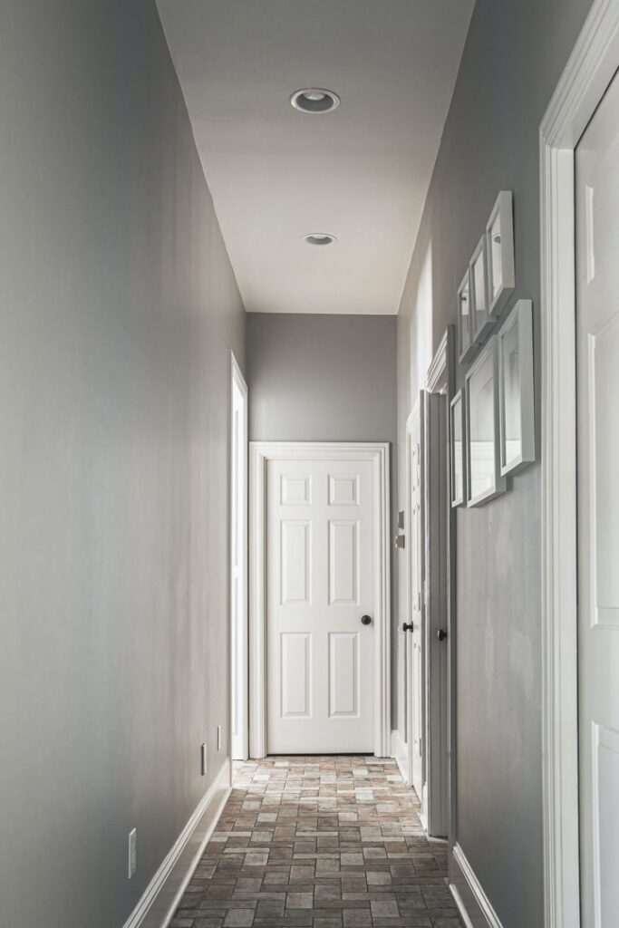 A modern hallway with freshly painted grey walls and a tiled floor by Harpeth Painting, LLC. in Nashville, TN.