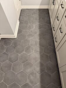 A newly installed grey hexagonal tile floor in a bathroom by Goubar Tile And More in Raleigh, NC.
