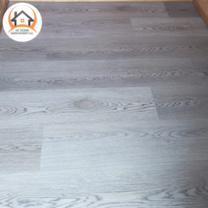 Close-up of newly installed grey wood-look laminate flooring by DC HOME improvement LLC in Orlando, FL.