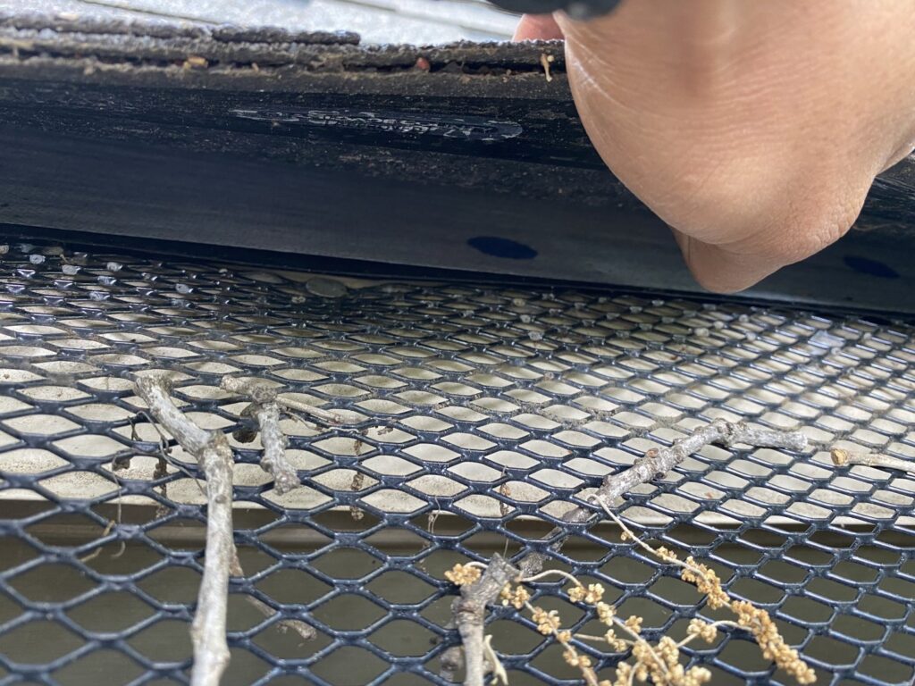 Close-up of a gutter guard installation or maintenance by Canek Construction LLC in Fort Worth, TX