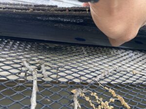 Close-up of a gutter guard installation or maintenance by Canek Construction LLC in Fort Worth, TX