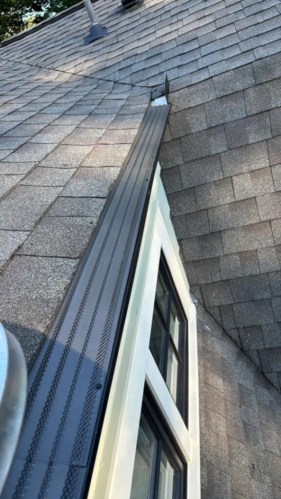 A newly installed gutter guard on a residential roof, a service provided by Zamora Roofing & Construction LLC in Madison, WI.