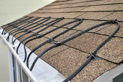 A gutter heating cable system installed on a roof to prevent ice dams by The Brothers that just do Gutters in Sioux Falls, SD.