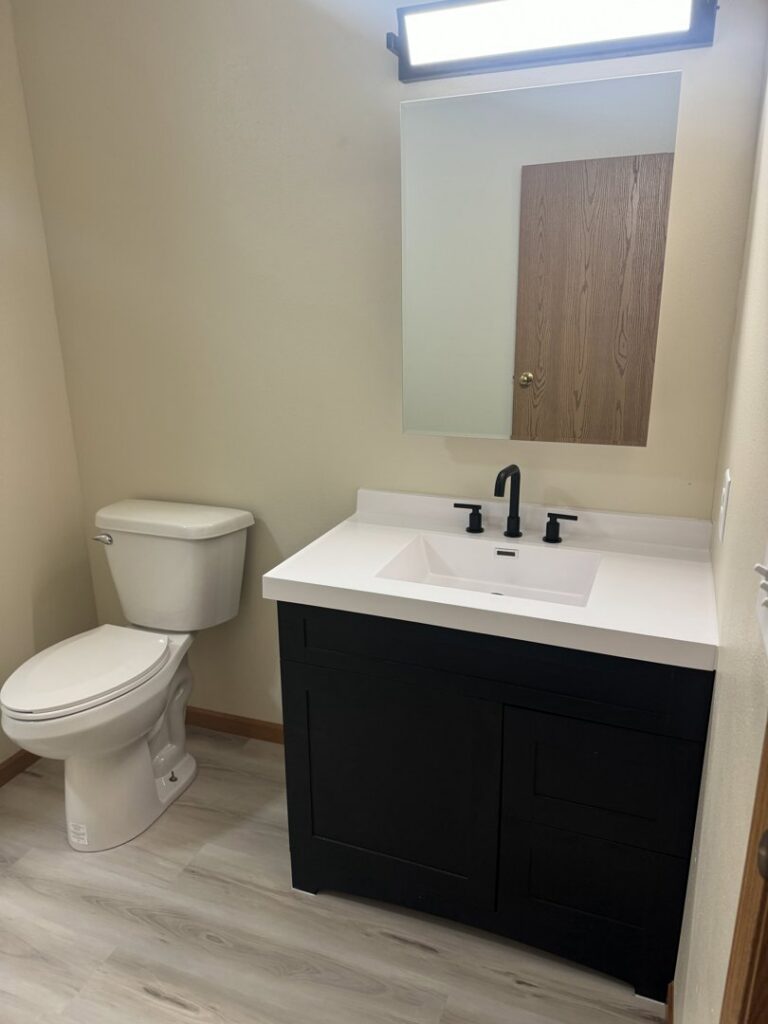 Half-bathroom renovation with new vanity, toilet, and flooring by Midwest Handyman LLC in West Fargo, ND.