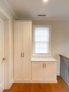 A hallway featuring custom built-in storage cabinets and a window seat by Closet Creations Inc. in Sleepy Hollow, NY.