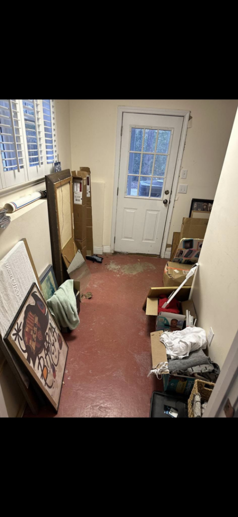 A hallway cluttered with boxes, framed art, and various household items, ready for junk removal by Pop's Pickup Junk & Trash Removal in Roswell, GA.