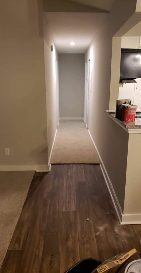 Hallway with new flooring and fresh paint by Sanchez Construction in Weimar, TX