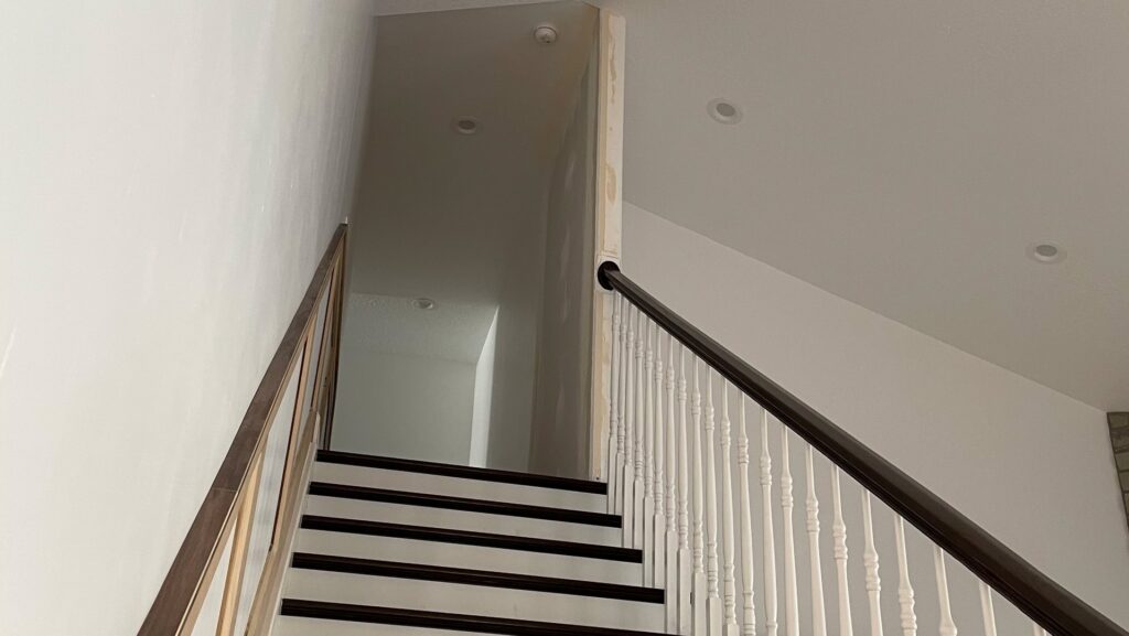 Renovated hallway with new dark flooring and white trim by Handyman house repairs and remodeling in Provo, UT