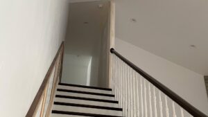 Renovated hallway with new dark flooring and white trim by Handyman house repairs and remodeling in Provo, UT