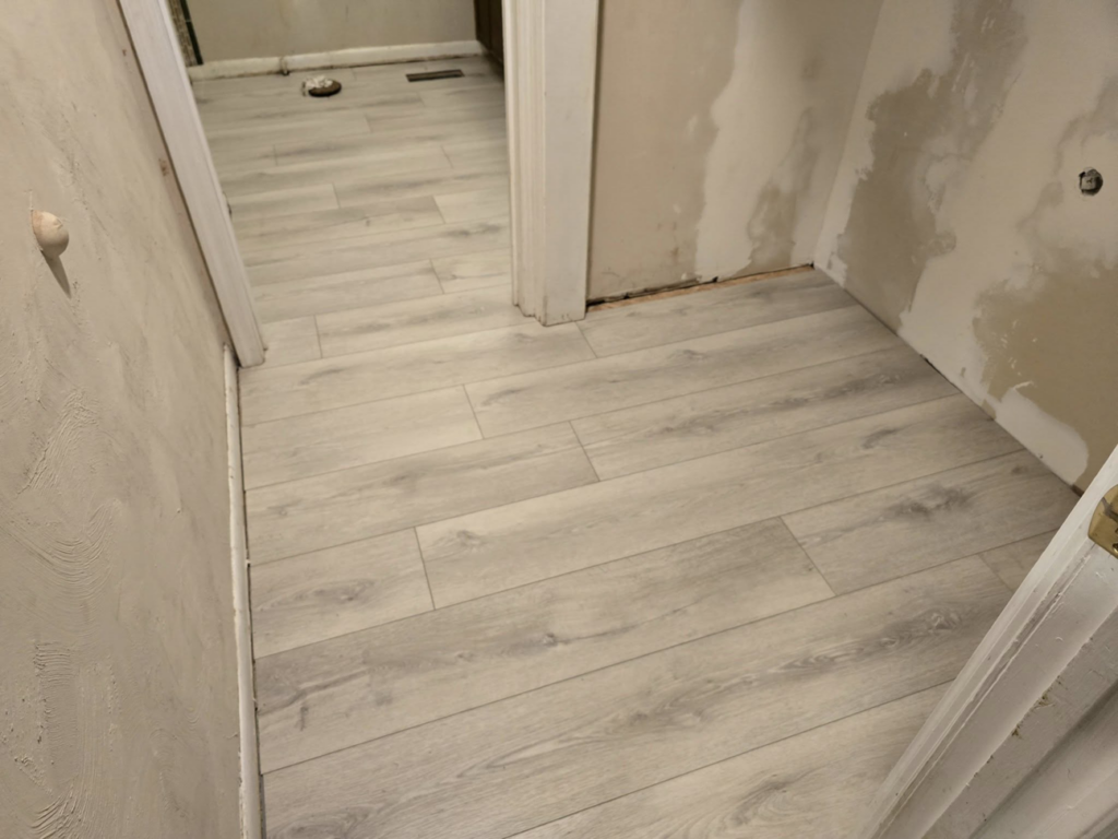 New light hardwood flooring installed in a hallway during a home renovation by Refined Hardwood Flooring LLC in Wilmington, NC