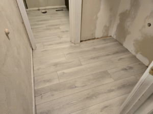 New light hardwood flooring installed in a hallway during a home renovation by Refined Hardwood Flooring LLC in Wilmington, NC
