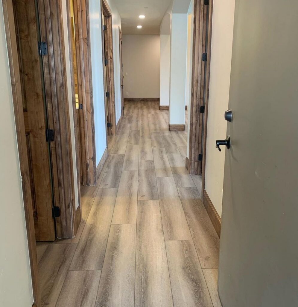 A renovated hallway with new flooring and wooden doors installed by Halpin Hands in Williams, OR.