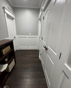 A renovated hallway featuring wainscoting and new doors installed by Handy Dad's in Seminole, FL