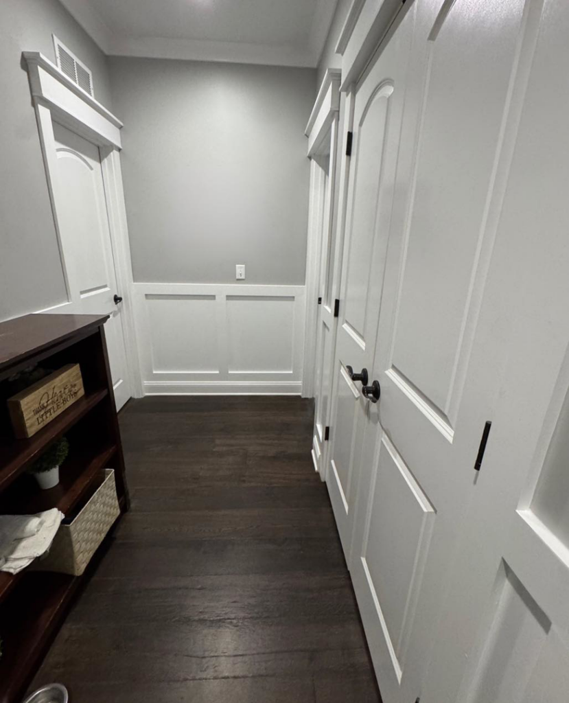 A renovated hallway featuring wainscoting and new doors installed by Handy Dad's in Seminole, FL