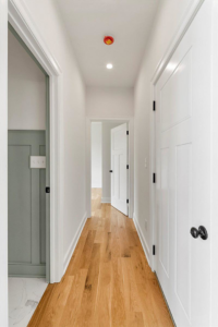 Hallway featuring clean, light hardwood floors installed or refinished by WoodHaven Floor Refinishing in Georgetown, KY.