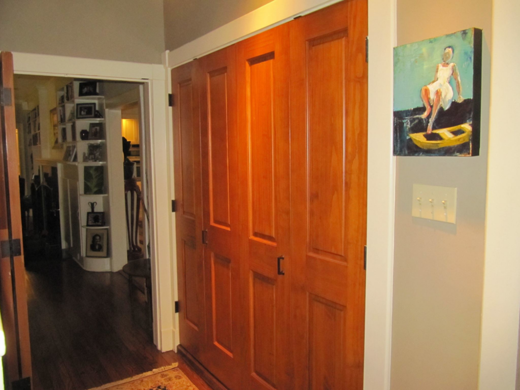 A renovated hallway featuring new wooden bifold doors installed by Jackson Construction in Oak Hills Place, LA