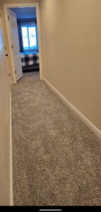 A hallway featuring new carpet installation, a home improvement service by Wam Bam Handyman LLC in Colorado Springs, CO
