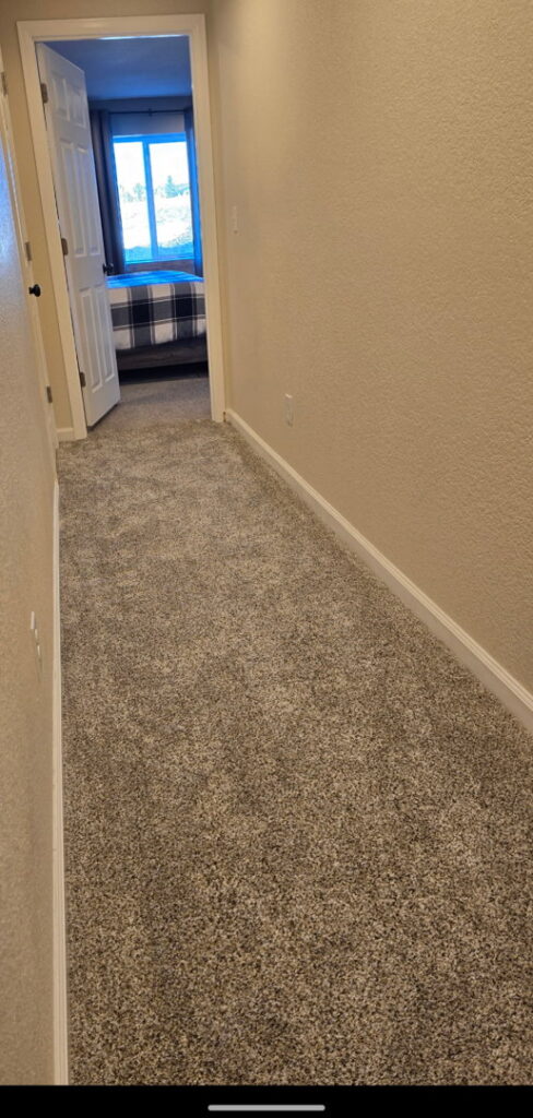 A hallway featuring new carpet installation, a home improvement service by Wam Bam Handyman LLC in Colorado Springs, CO